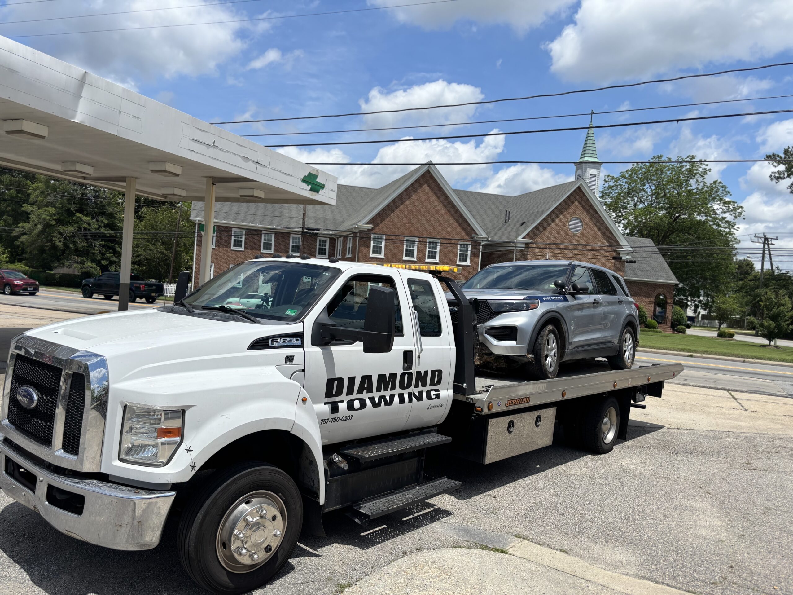 Diamond Towing flatbed transporting a Virginia State Police cruiser